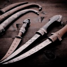 several different types of knifes on a table next to each other with holes in them