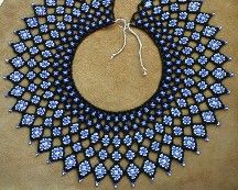 a black and blue beaded necklace on a table