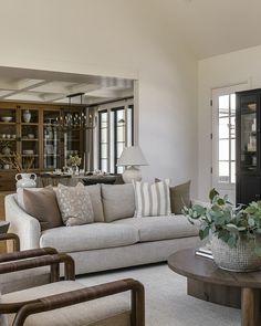 a living room filled with furniture and lots of windows