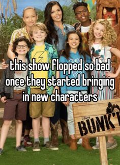 people posing for a photo in front of a sign that says, this show flopped so bad one they started bringing in new characters