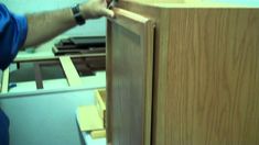 a man is working on some wood furniture