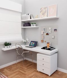 a white desk with a laptop on top of it next to a chair and shelves