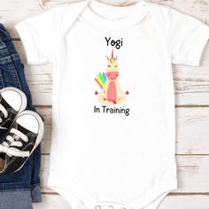 This fun infant bodysuit is perfect for moms who love yoga and hope their baby will follow in their footsteps!  This colorful unicorn graphic onsie would make a great baby shower gift for a yoga enthusiast.  Comes in White, Pink, Gray, and Light Blue. This one-piece shirt is both durable and soft.  There are seams along the sides. All bindings are made with ribbed knitting for improved durability. There are plastic snaps at the cross closure for easy changing access.  .: 100% Combed ringspun cot Playful Stretch White Bodysuit, Playful White Stretch Bodysuit, White Stretch Bodysuit For Playtime, Playful White Stretch Onesie, White Stretch Playful Onesie, Yoga Baby, Colorful Unicorn, Unicorn Graphic, At The Cross