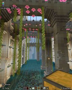 the inside of a building with pink flowers hanging from it