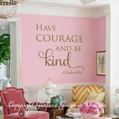 a living room with pink chairs and a quote on the wall that says, have courage and be kind