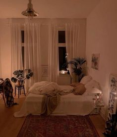 a bedroom with a bed, rug and two candles on the floor in front of it