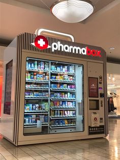 a pharmacy vending machine in the middle of a shopping mall with its doors open