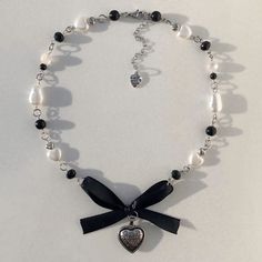 a black and white necklace with a heart on it