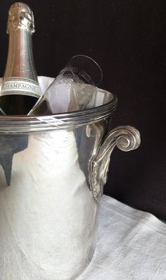 a bottle of champagne in a silver ice bucket