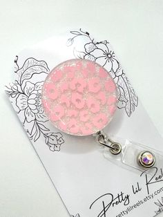 ✨Add some sparkle to your ID badge.  1.5" circle shaped acrylic decorated with glitter, vinyl and resin.  Your choice of alligator or slide clip badge reel.  **Please Note: Alligator clips are heavier and badge reel may droop. Pink Badge Holder With Swivel Clip As Gift, Fun Pink Badge Reel For Gift, Pink Badge Reel With Swivel Clip As Gift, Customizable Adjustable Pink Badge Reel, Novelty Personalized Pink Badge Reel, Novelty Pink Personalized Badge Reel, Surgical Tech, Multicolor Retractable Badge Reel, Nurse Badge Reel