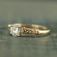 a yellow gold engagement ring with a single diamond