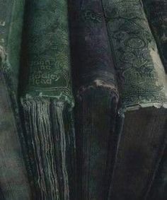 several old books are stacked on top of each other