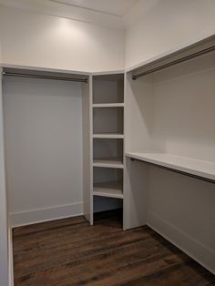 an empty walk in closet with white walls