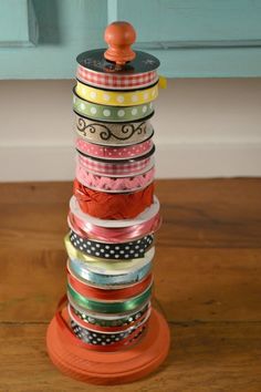 a stack of ribbons sitting on top of a wooden table