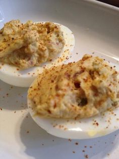 three deviled eggs sitting on top of a white plate