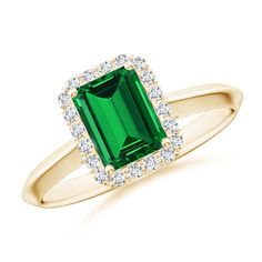 an emerald and diamond ring in yellow gold