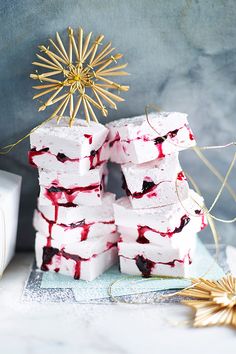 white marshmallows stacked on top of each other in front of a star decoration