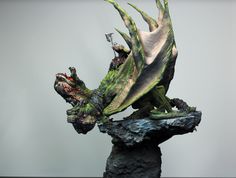 a statue of a dragon on top of a rock