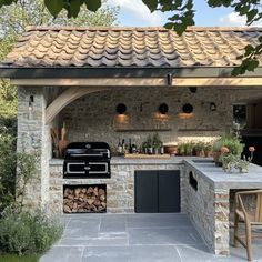 an outdoor kitchen that is built into the side of a house