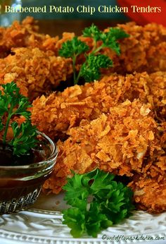 baked potato chip chicken tenders on a white plate with garnished parsley