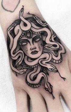 a woman's hand with a tattoo on it