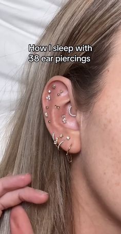 a woman wearing ear piercings with the words how i sleep with 3 / 8 ear piercings