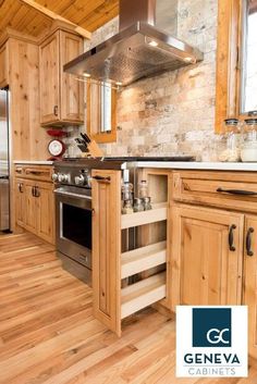 a kitchen with wooden cabinets and stainless steel stove top oven in the center, surrounded by wood flooring