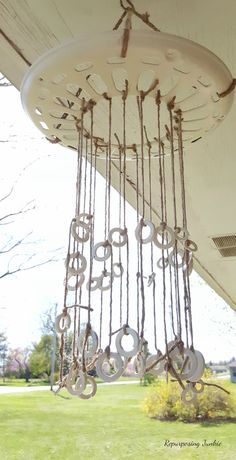 the words rustic wind chimes using repurposed materials are shown above an outdoor chandelier