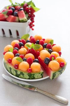 there is a watermelon and berries cake on the plate