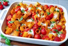 a casserole dish filled with pasta and tomatoes