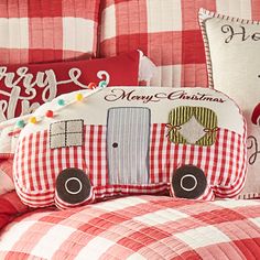 a red and white checkered comforter set with christmas decorations on the pillow cases