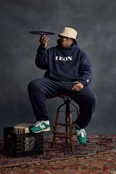 a man sitting on top of a stool holding a frisbee in his hand