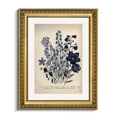 blue flowers in a gold frame on a white wall