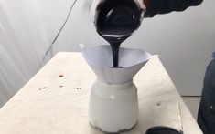 a person pours coffee into a cup