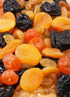 a mixture of raisins, apricots and oranges on top of each other