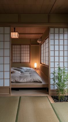 a bed sitting in the middle of a room next to a lamp and some plants