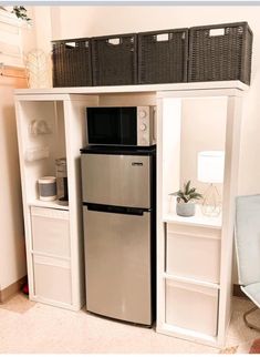 a refrigerator freezer sitting inside of a kitchen next to a shelf filled with baskets