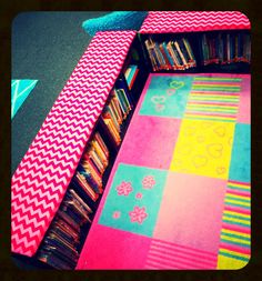 a tie is laying on top of a bookcase in a library with bookshelves