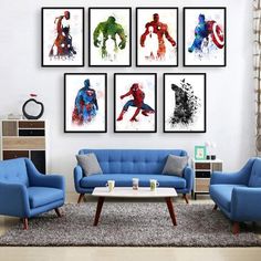 a living room filled with blue couches and paintings on the wall above them,