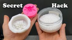 two hands holding small containers filled with white sugar and one has a pink lid that says secret hack