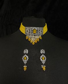 Women's Silver Plated pendant jewelry - Yellow Bridal Choker Set & Earrings of CZ crystals A silver-plated choker with yellow onyx drops adorns this bridal choker necklace. Contemporary ladies' bridal set with multilayered bead strands choker and Kundan gemstone earrings. This bridal choker jewelry set is accented with yellow onyx & Kundan pendant making it one of a kind. The pendant of a square-shaped design is studded with CZ crystals & yellow Onyx. This contemporary choker is sure to make you Yellow Diamond Necklaces For Wedding, Yellow Diamond Necklace For Wedding, Traditional Yellow Jewelry For Formal Occasions, Elegant Yellow Choker Jewelry, Traditional Yellow Formal Jewelry, Heavy Yellow Jewelry As A Gift, Yellow Diamond Jewelry For Parties, Yellow Necklace For Festive Formal Occasions, Yellow Necklace For Formal Festive Occasions