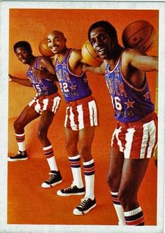 three basketball players are posing with their arms around each other and one is holding a ball