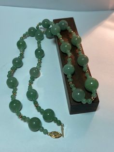 This is a beautiful, vintage, natural, genuine 14K yellow gold, green jade and 14K gold beads necklace. The necklace is about 25 1/2 inches.  The necklace is so unique and features large, natural, round green jade that is 13mm (about 1/2" in diameter) then there are 2 smaller, natural, round green jade that are 5mm (about 3/16" in diameter) separated with a 14K yellow gold bead that is about 1/8" in diameter. So there are 4 smaller green jade balls and 1 14K yellow gold bead between each of the larger green jade balls. The high-quality jade is a gorgeous green color. Just stunning and very well-made. The necklace has a secure 14K slide clasp that is ornate with a flower on it. The necklace weighs an impressive 58.2 grams. It is marked 14K WW. I am unsure who the artisan is who uses that ha Swamp Princess, Gold Beads Necklace, Vintage Navajo Jewelry, Green Jade Necklace, Tibetan Jewelry, Navajo Jewelry, Gold Bead Necklace, Jade Necklace, Green Jade