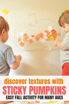 two young boys playing with sticky pumpkins on the wall in front of a white background