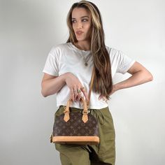 Louis Vuitton brown monogram canvas Alma BB with brass hardware, dual rolled natural leather top handles, removeable leather shoulder strap, protective feet at base, tonal canvas lining, single slip pocket at interior wall and zip closure at top. Includes padlock, key, and dustbag. d . From 2020 Condition: 9/10 Excellent. Minimal patina, residue and water staining to leather. Details: Shoulder Strap Drop: 22" Handle Drop: 3" Height: 7" Width: 9" Depth: 4.75" Everyday Monogram Canvas Satchel With Detachable Strap, Classic Monogram Canvas Satchel For Everyday, Monogram Canvas Satchel With Leather Trim For Everyday Use, Everyday Monogram Canvas Satchel With Leather Trim, Fancy N, Alma Bb, Louis Vuitton Brown, Interior Wall, Fendi Bags