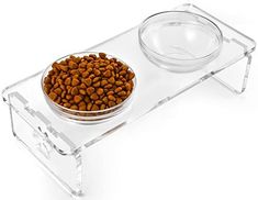 a clear acrylic dog bowl with two bowls on it and one is filled with food