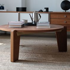 a coffee table with books on it in a living room