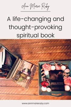 an open book sitting on top of a wooden table next to candles and bookshelves