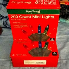 a christmas light display in a box on a bed