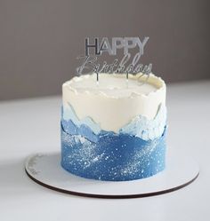 a blue and white frosted birthday cake with the words happy birthday written on it